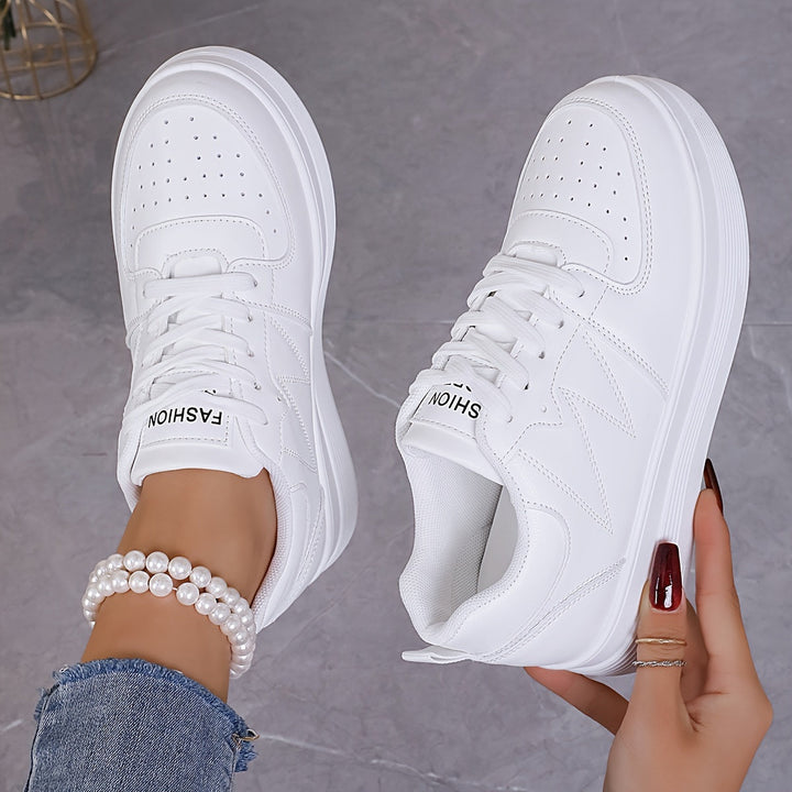 A woman wearing elegant two-tone platform trainers in the city