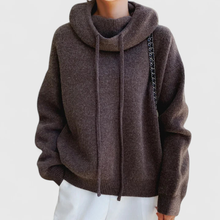 A woman wearing a cosy navy hoodie with jeans for a relaxed everyday look.