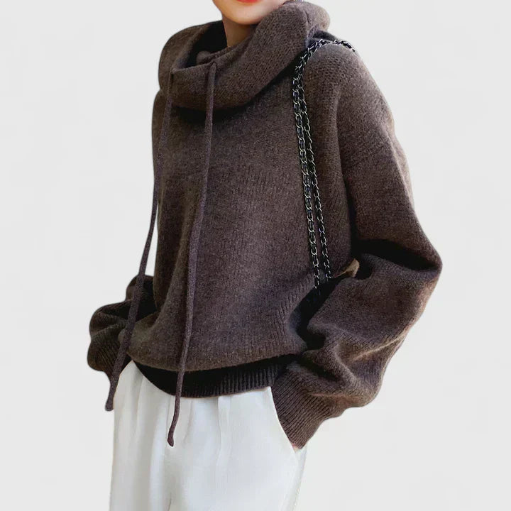 A woman wearing a cosy navy hoodie with jeans for a relaxed everyday look.