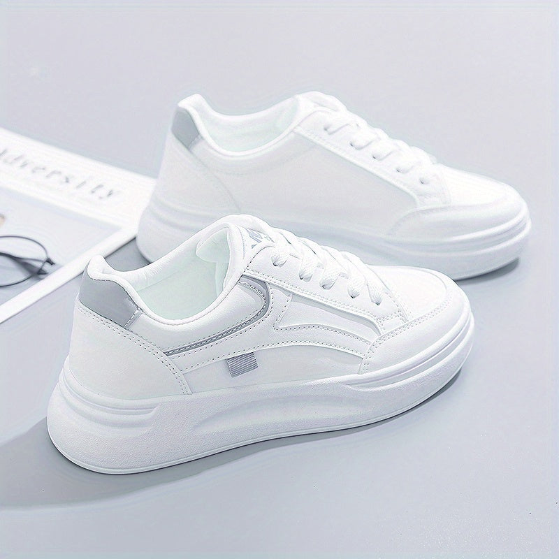 A woman in crisp white light comfort trainers paired with jeans.