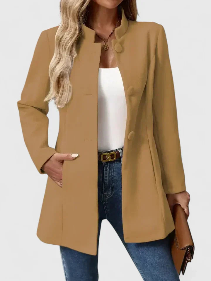A woman wearing a collarless tailored jacket with a button front