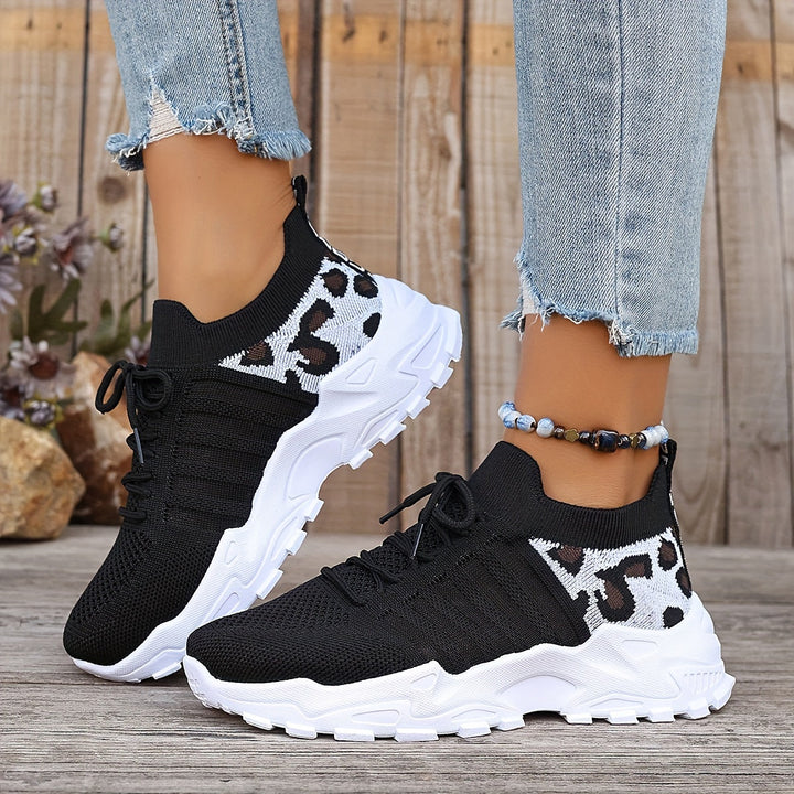 A woman walking in light, breathable comfort trainers on a warm day.
