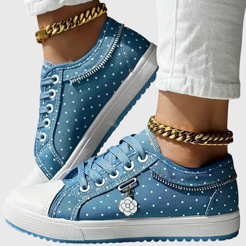 A woman walking comfortably in blue cushioned orthopaedic trainers