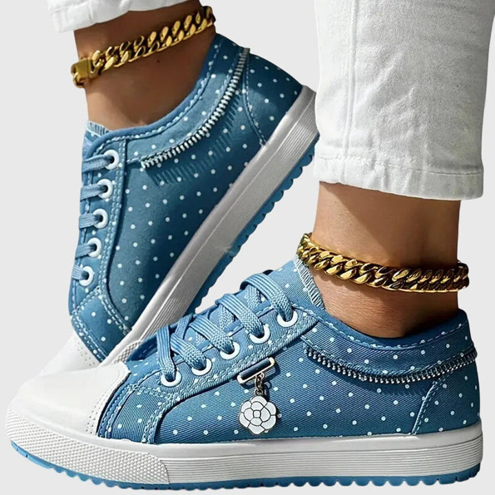A woman walking comfortably in blue cushioned orthopaedic trainers