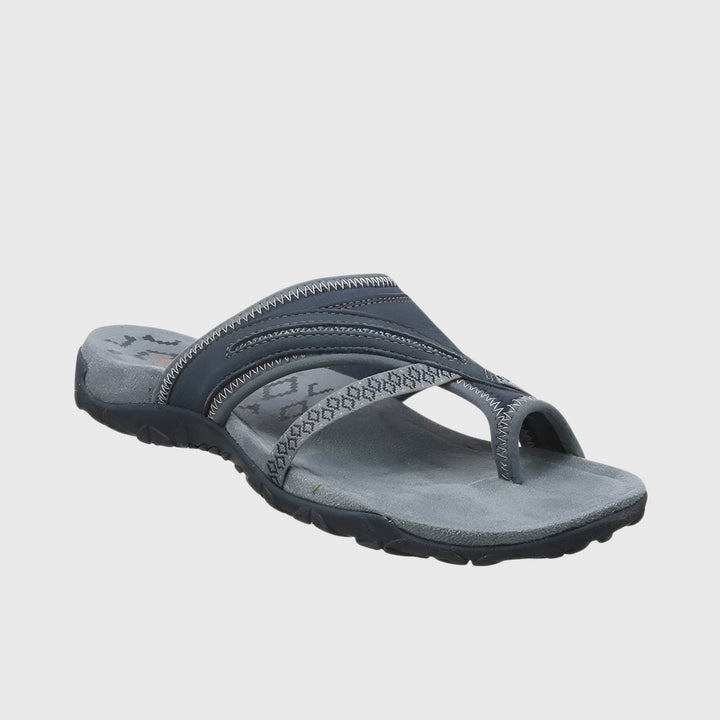A woman wearing open-toe supportive sandals with a light summer outfit, walking comfortably and looking confident.