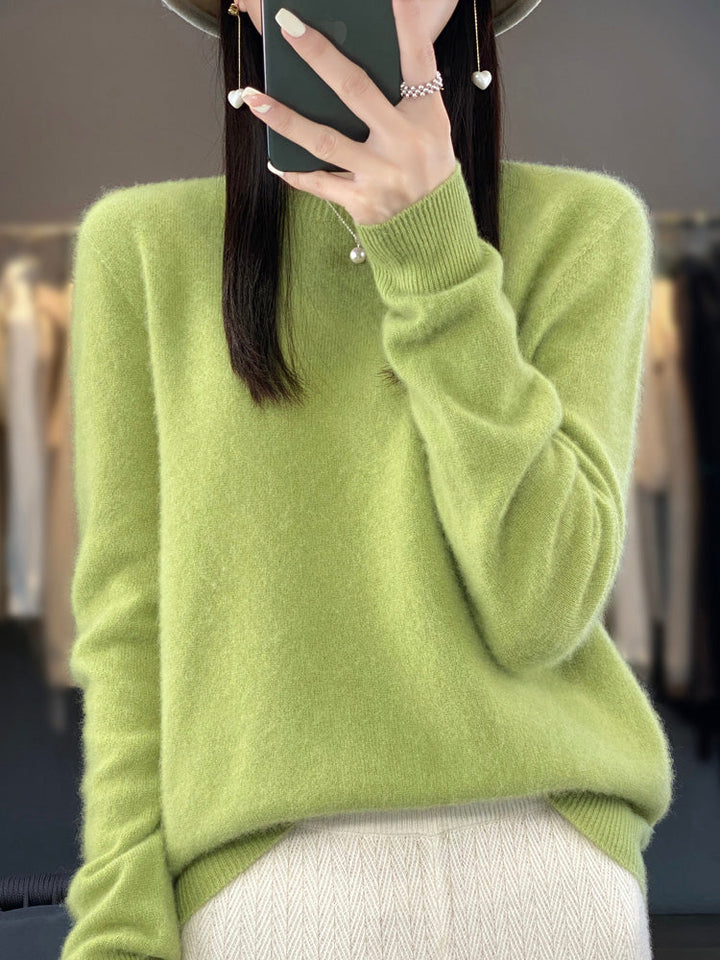 A woman wearing a super-soft warm jumper, relaxed and cosy on a chilly day.