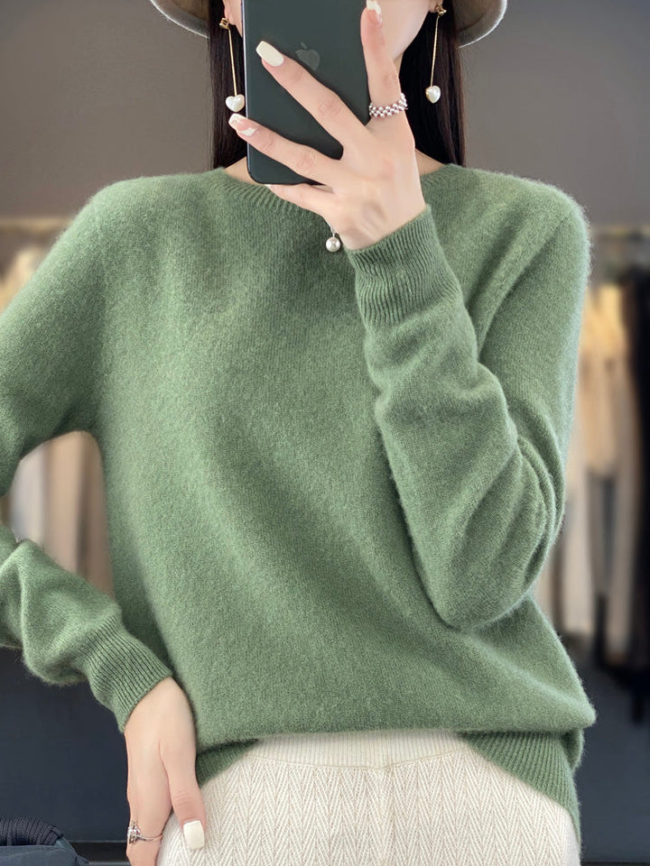A woman wearing a super-soft warm jumper, relaxed and cosy on a chilly day.