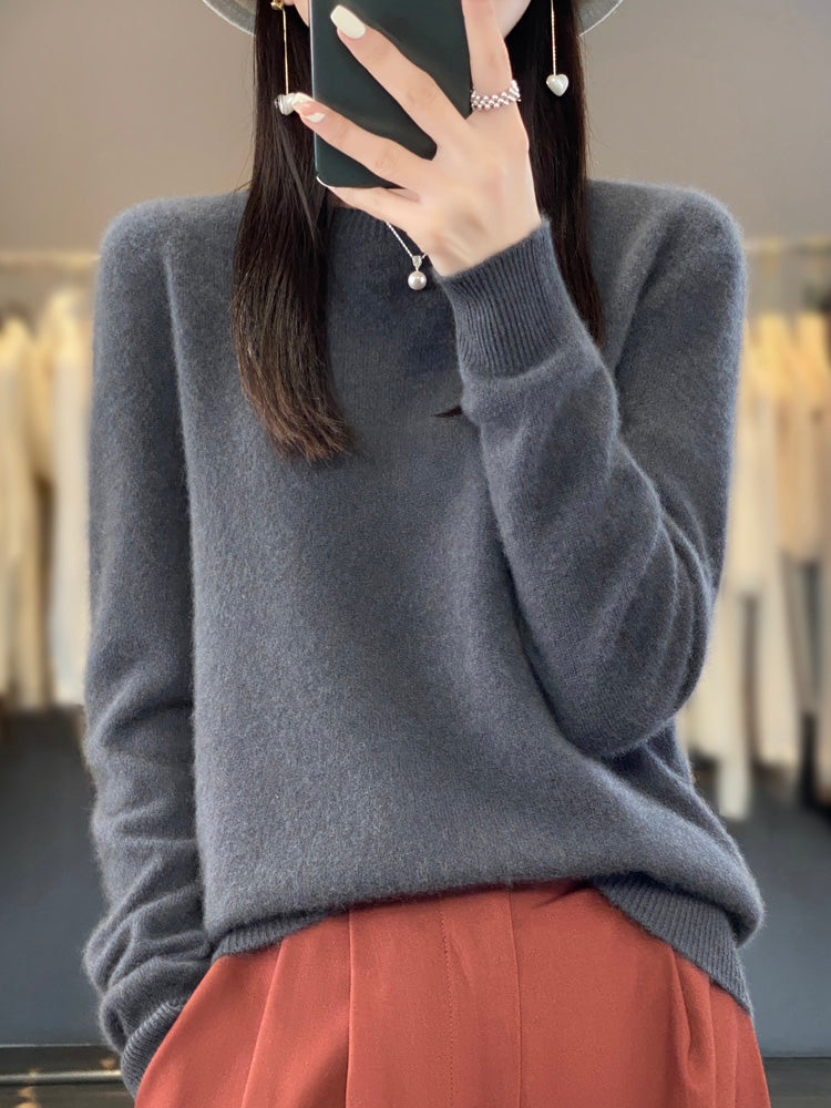 A woman wearing a super-soft warm jumper, relaxed and cosy on a chilly day.