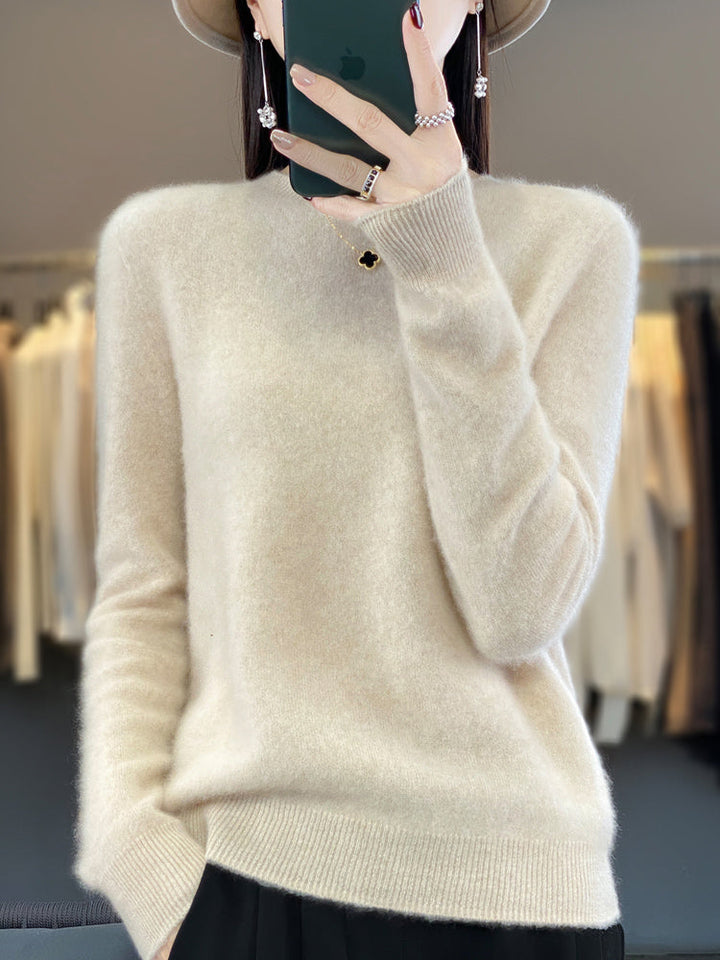 A woman wearing a super-soft warm jumper, relaxed and cosy on a chilly day.