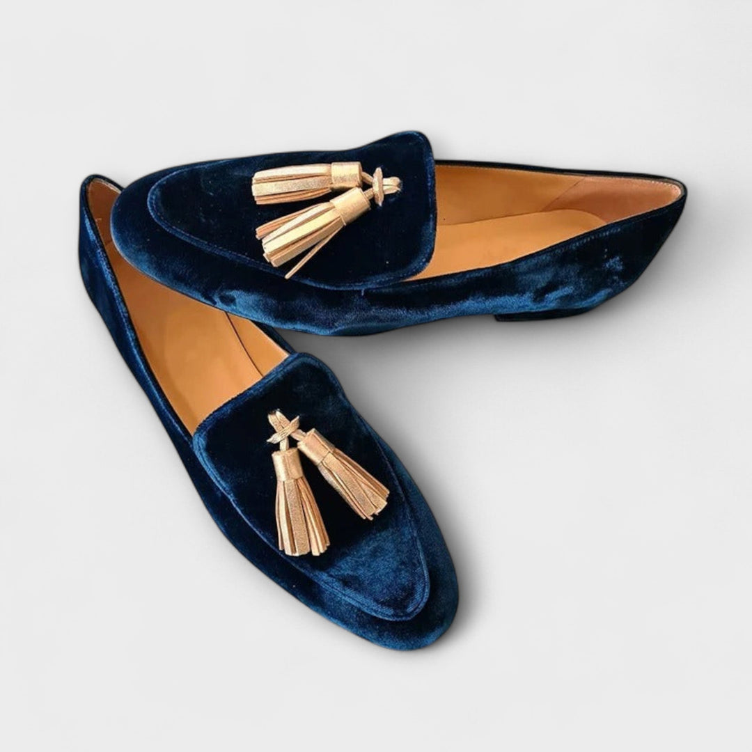 A woman wearing vintage-style loafers with fine fringing and a relaxed outfit