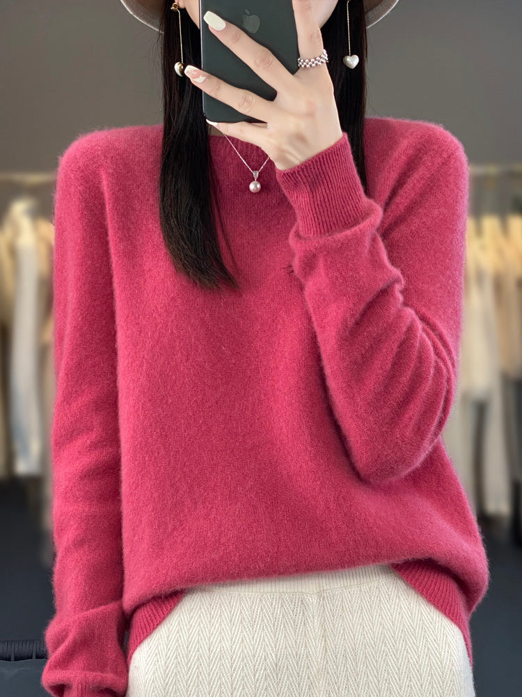 A woman wearing a super-soft warm jumper, relaxed and cosy on a chilly day.