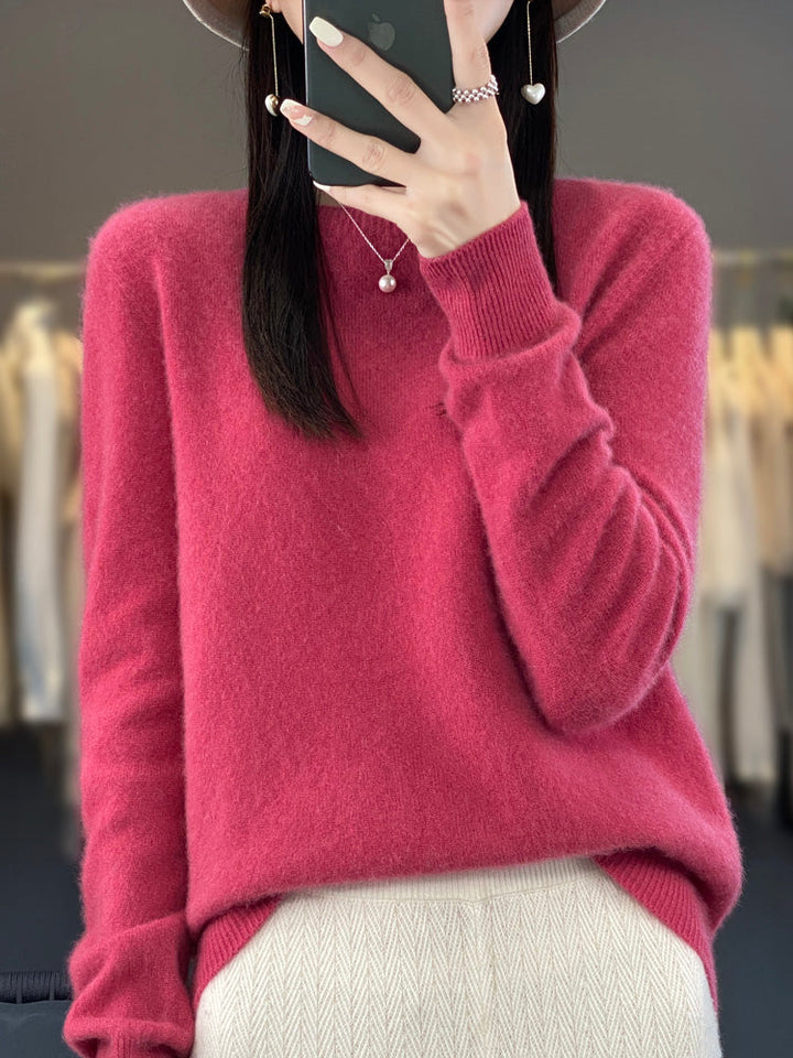A woman wearing a super-soft warm jumper, relaxed and cosy on a chilly day.