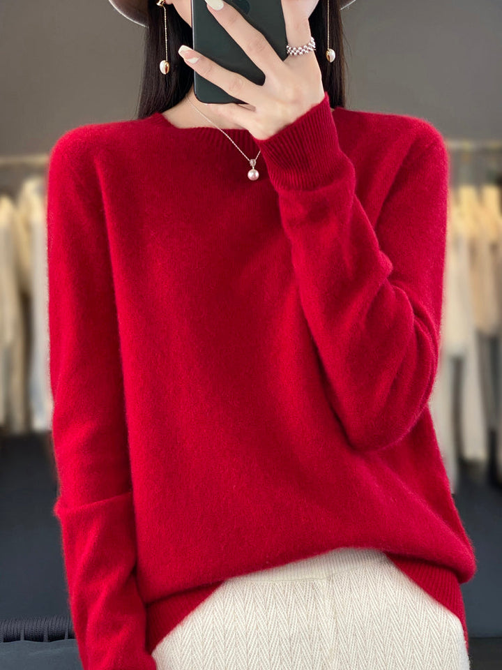 A woman wearing a super-soft warm jumper, relaxed and cosy on a chilly day.