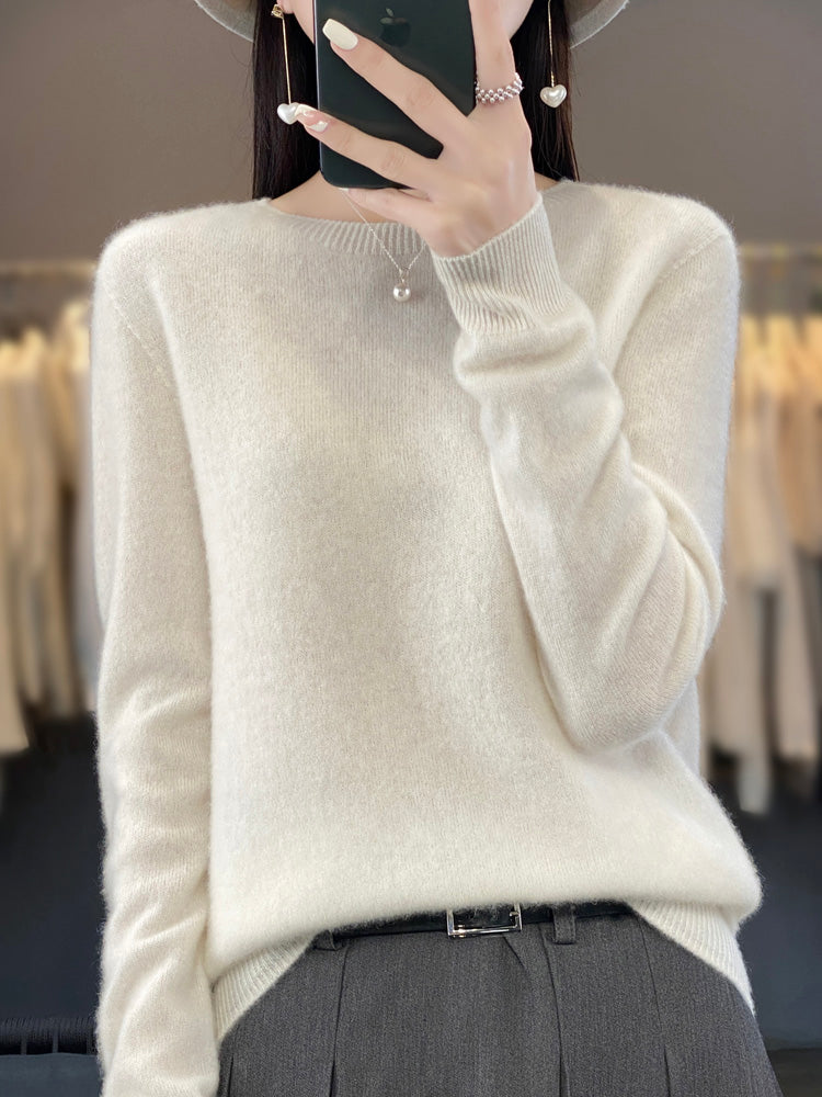 A woman wearing a super-soft warm jumper, relaxed and cosy on a chilly day.