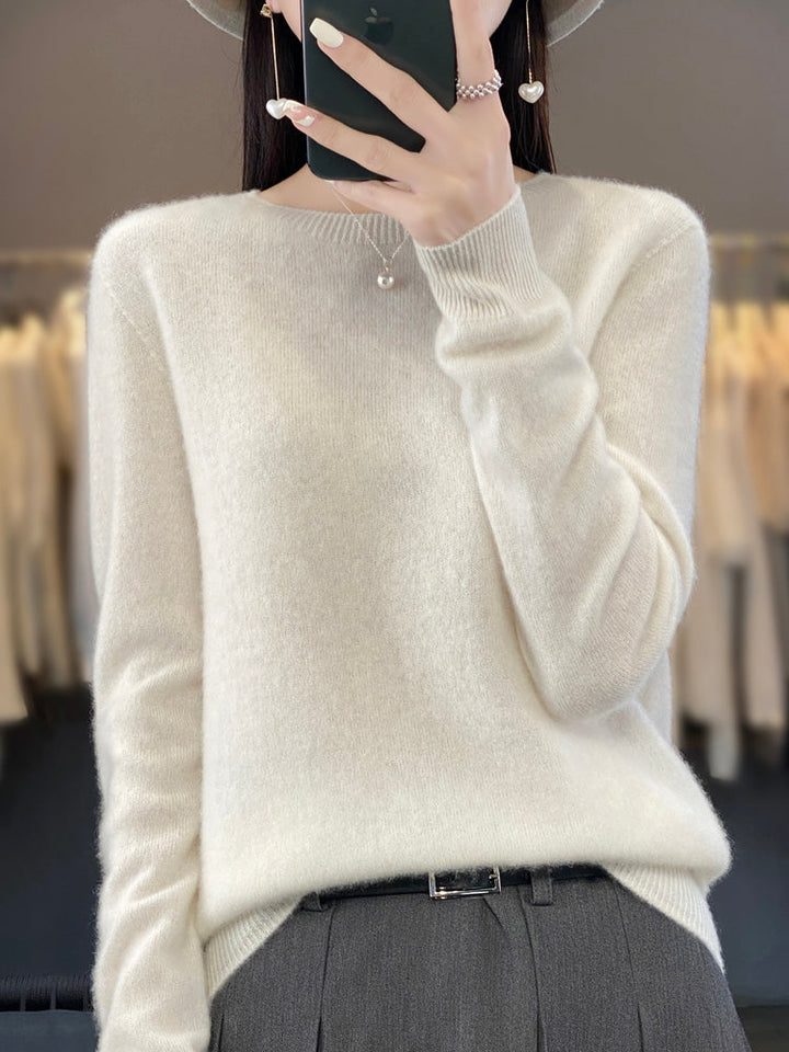 A woman wearing a super-soft warm jumper, relaxed and cosy on a chilly day.