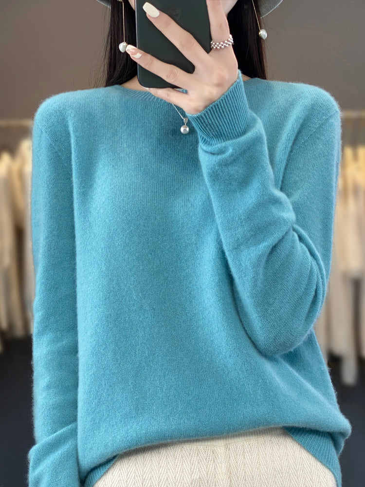 A woman wearing a super-soft warm jumper, relaxed and cosy on a chilly day.