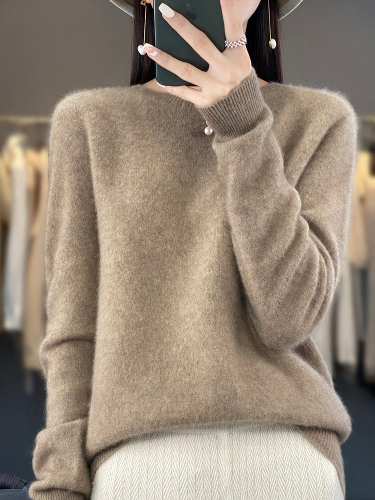A woman wearing a super-soft warm jumper, relaxed and cosy on a chilly day.