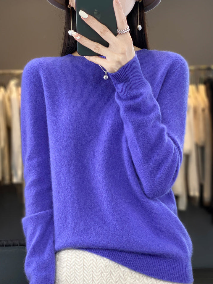 A woman wearing a super-soft warm jumper, relaxed and cosy on a chilly day.