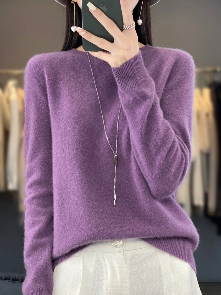 A woman wearing a super-soft warm jumper, relaxed and cosy on a chilly day.