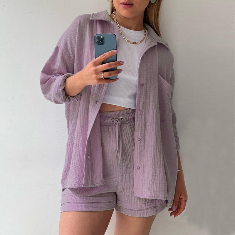 A woman wearing a soft V-neck blouse with matching playful shorts, fresh and relaxed.