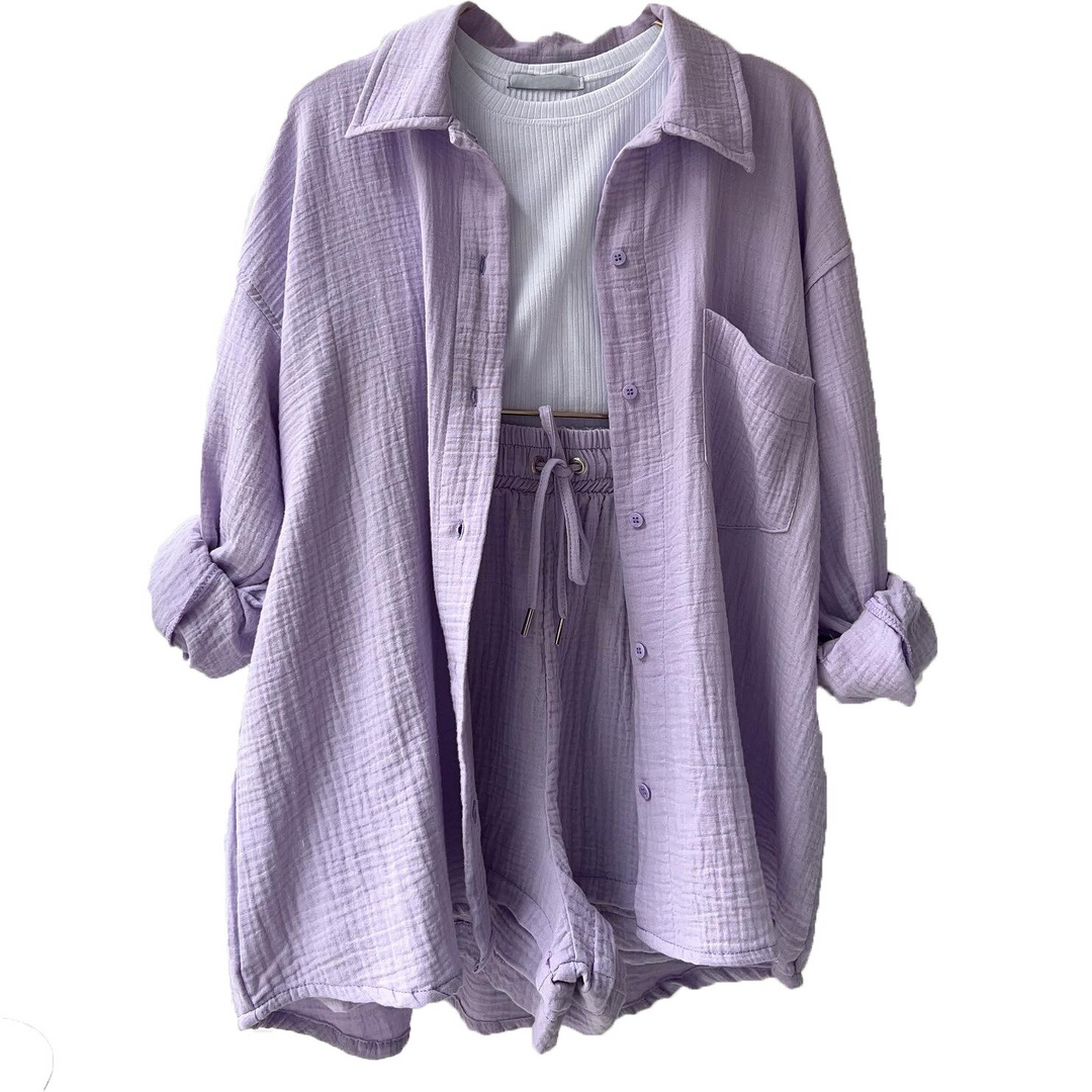 A woman wearing a relaxed button shirt with matching drawstring shorts, fresh and easy.