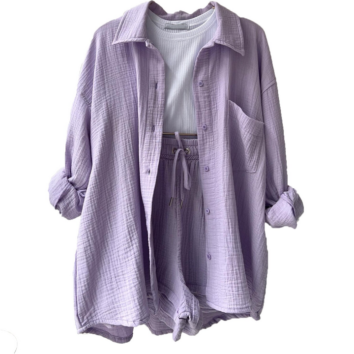 A woman wearing a relaxed button shirt with matching drawstring shorts, fresh and easy.