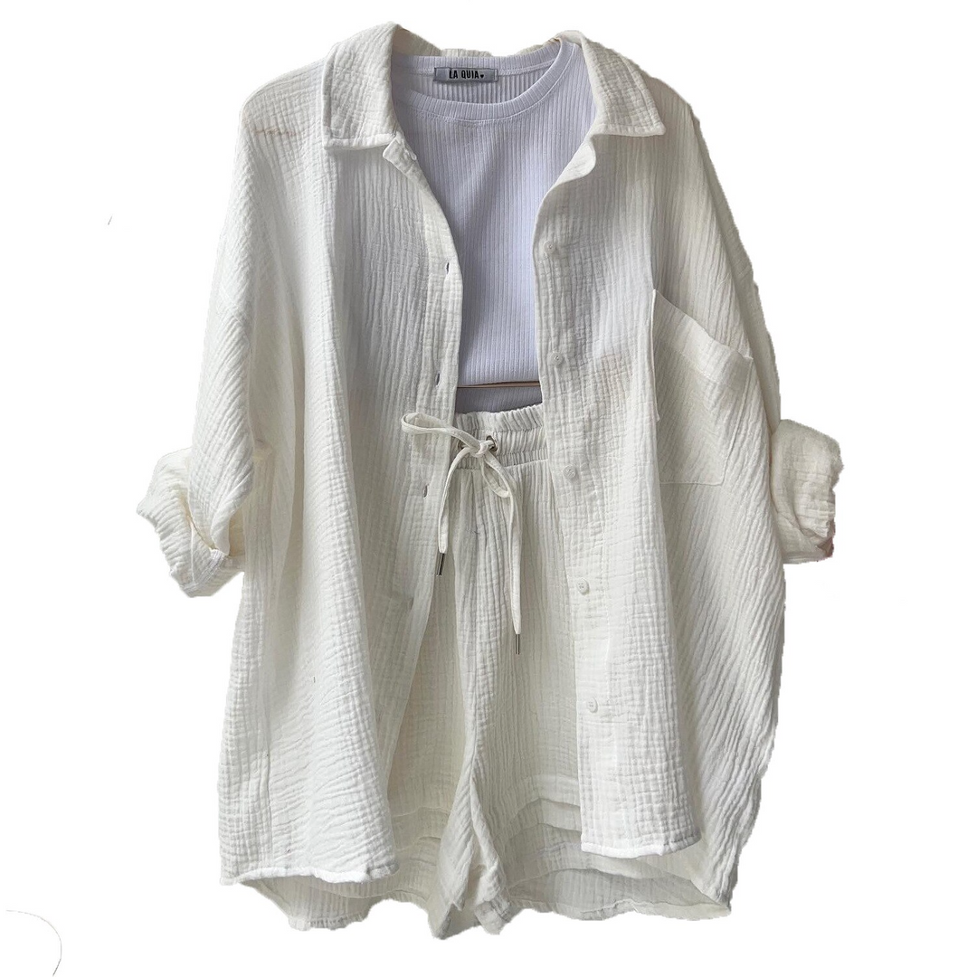 A woman wearing a soft V-neck blouse with matching playful shorts, fresh and relaxed.