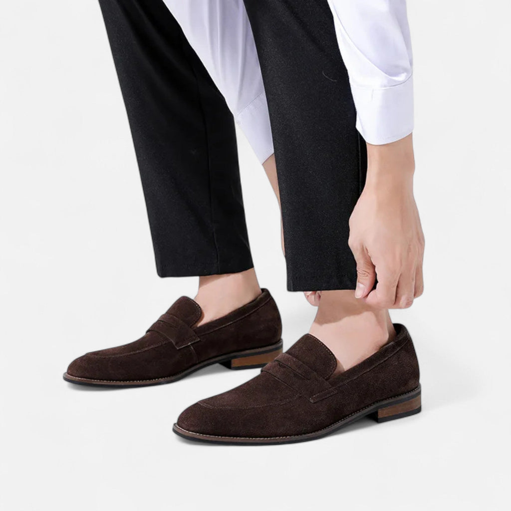 Men's tan coffee penny loafers with a clean structured upper and classic loafer silhouette