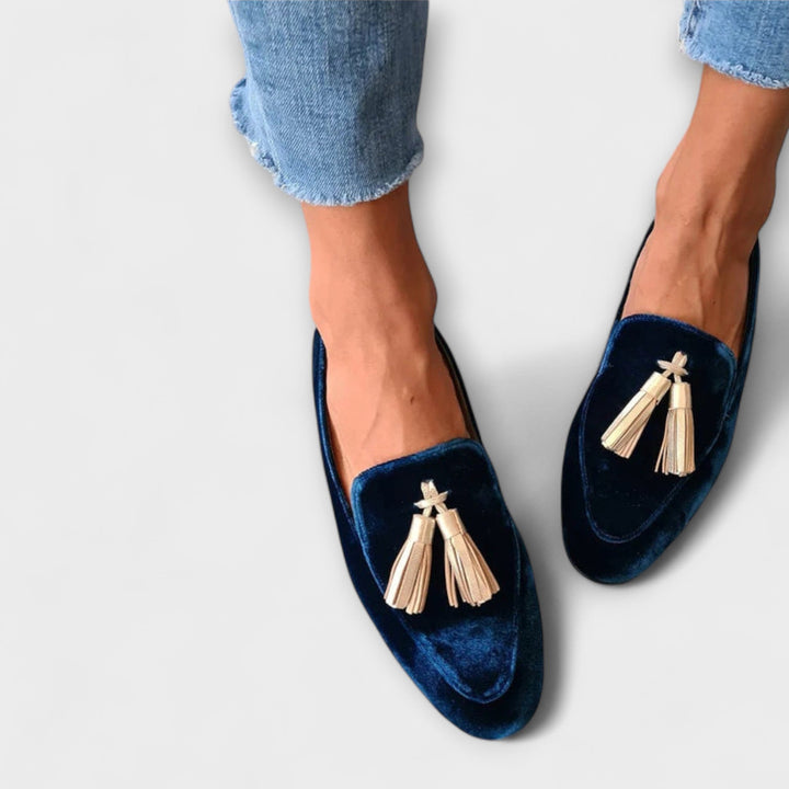 A woman wearing vintage-style loafers with fine fringing and a relaxed outfit
