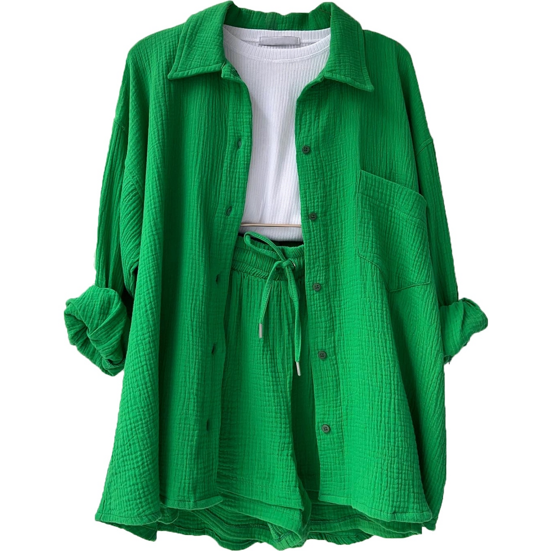 A woman wearing a relaxed button shirt with matching drawstring shorts, fresh and easy.