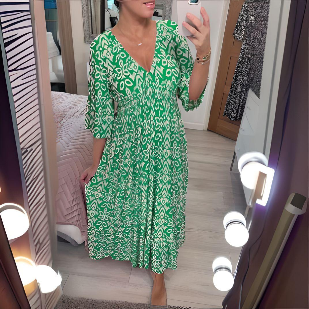 Woman wearing the Nuala™ bold printed boho maxi dress with a V-neckline, smiling outdoors in the sunshine.