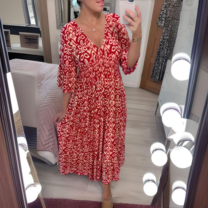 Woman wearing the Nuala™ bold printed boho maxi dress with a V-neckline, smiling outdoors in the sunshine.