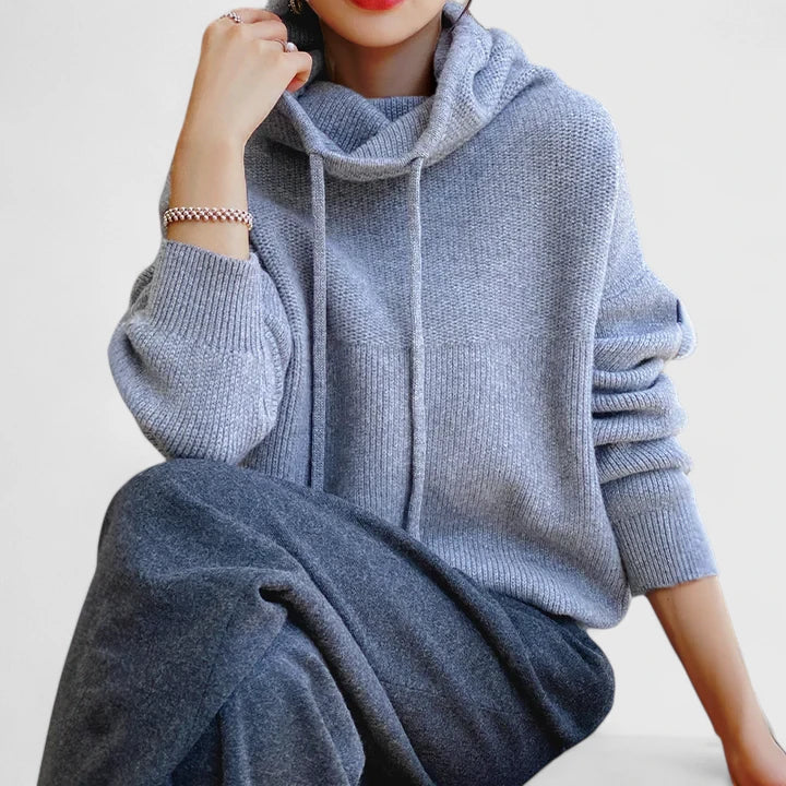 A woman wearing a cosy navy hoodie with jeans for a relaxed everyday look.