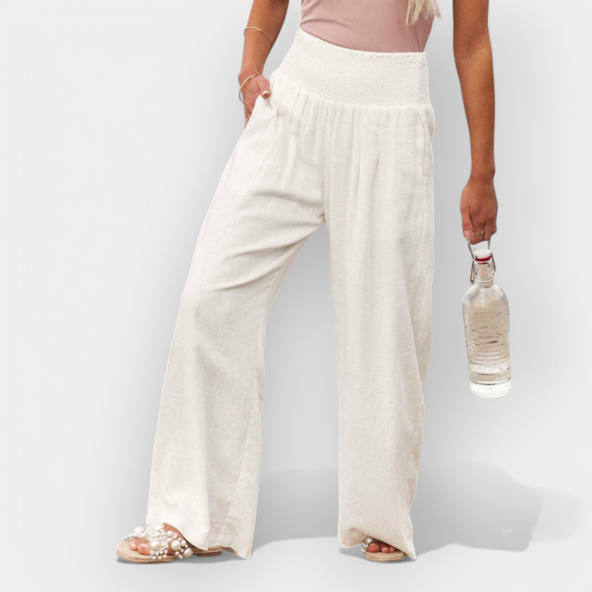 White wide-leg trousers with an elastic waist and a light, flowing silhouette