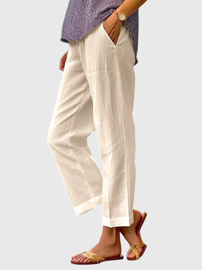 A woman wearing elegant tailored trousers with a flattering straight-leg cut and clean lines.