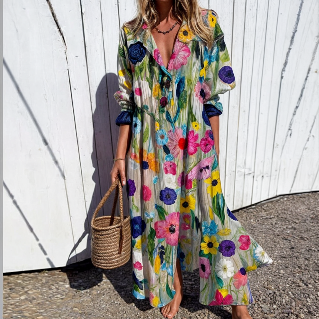 Woman wearing the Zara™ leaf print maxi dress with a button front, walking along the coast in a light breeze.
