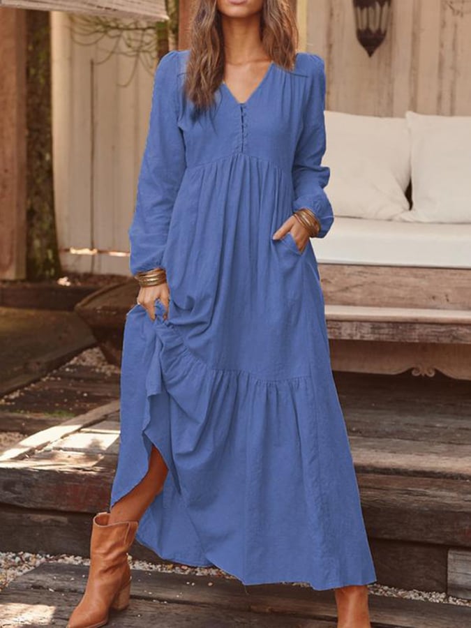 Woman walking through the countryside in the Georgia tiered maxi dress with long sleeves and a flowing flounced hem.