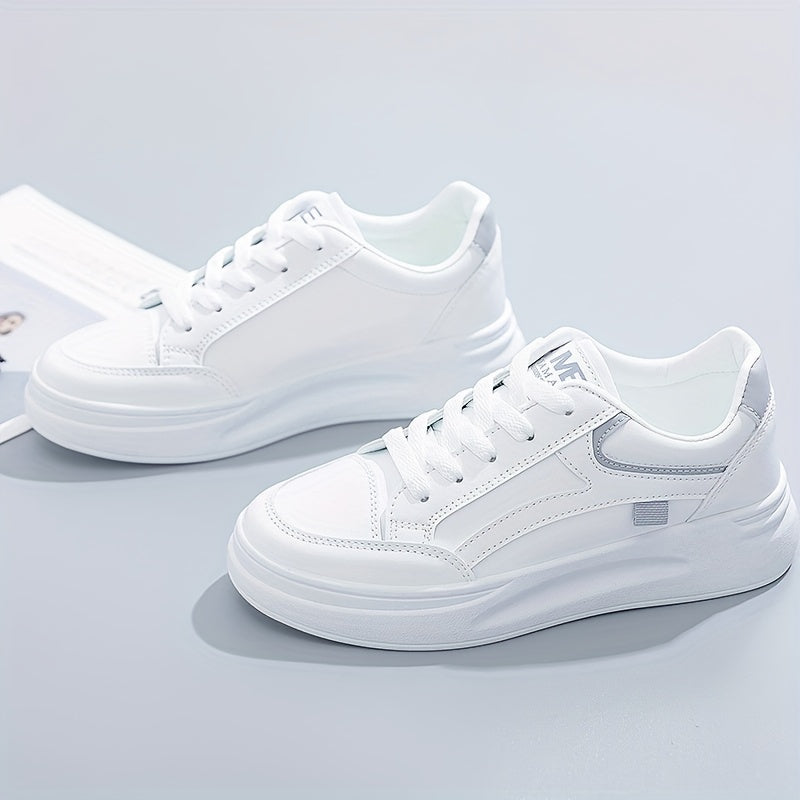 A woman in crisp white light comfort trainers paired with jeans.