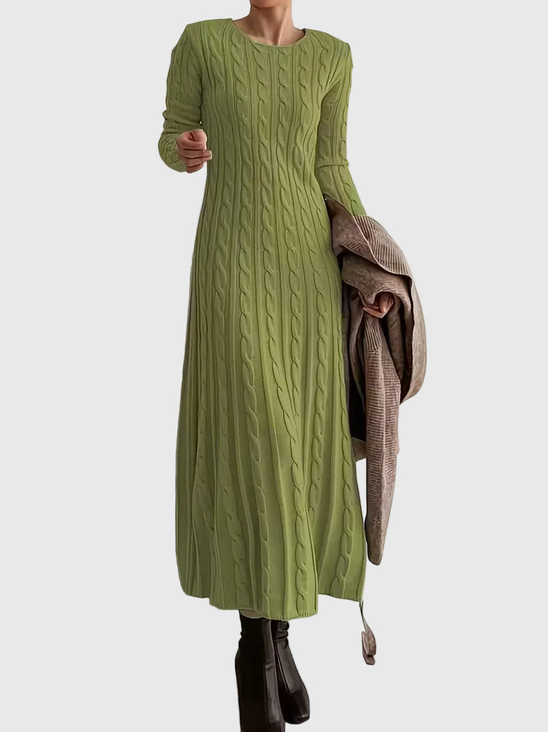 Woman wearing the Laoise cable-texture maxi dress in soft cream, styled with boots.