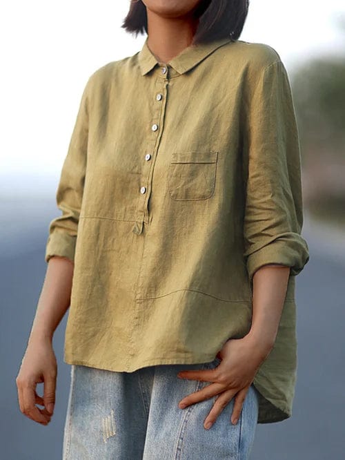 Woman wearing a flowing printed summer blouse that falls softly around her figure.