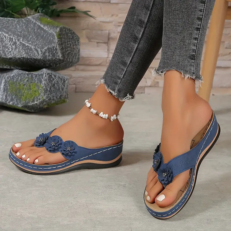 Women's floral toe-post sandals with a soft cushioned base in dark brown, black, navy, red and rose