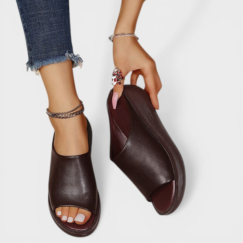 Open wedge mule sandals in white and brown with wide straps and a balanced wedge sole