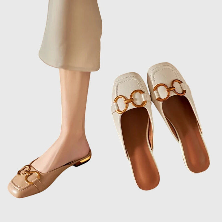A woman walking easily in beige everyday support sandals with a broad, cushioned footbed.