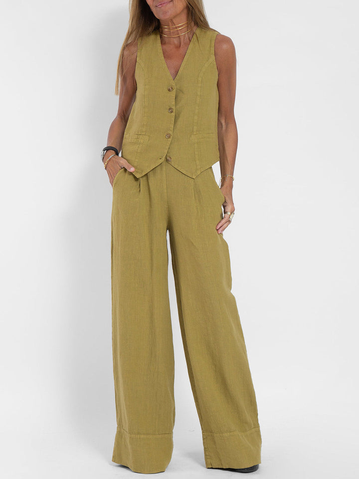 A woman wearing a tailored waistcoat with flowing wide-leg trousers