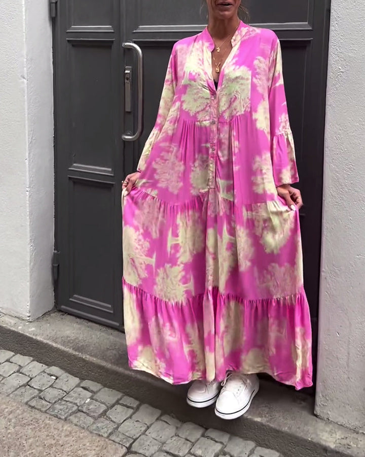 Woman wearing the Abigail flowing maxi dress with a delicate print and V-neckline, the skirt moving softly as she walks.
