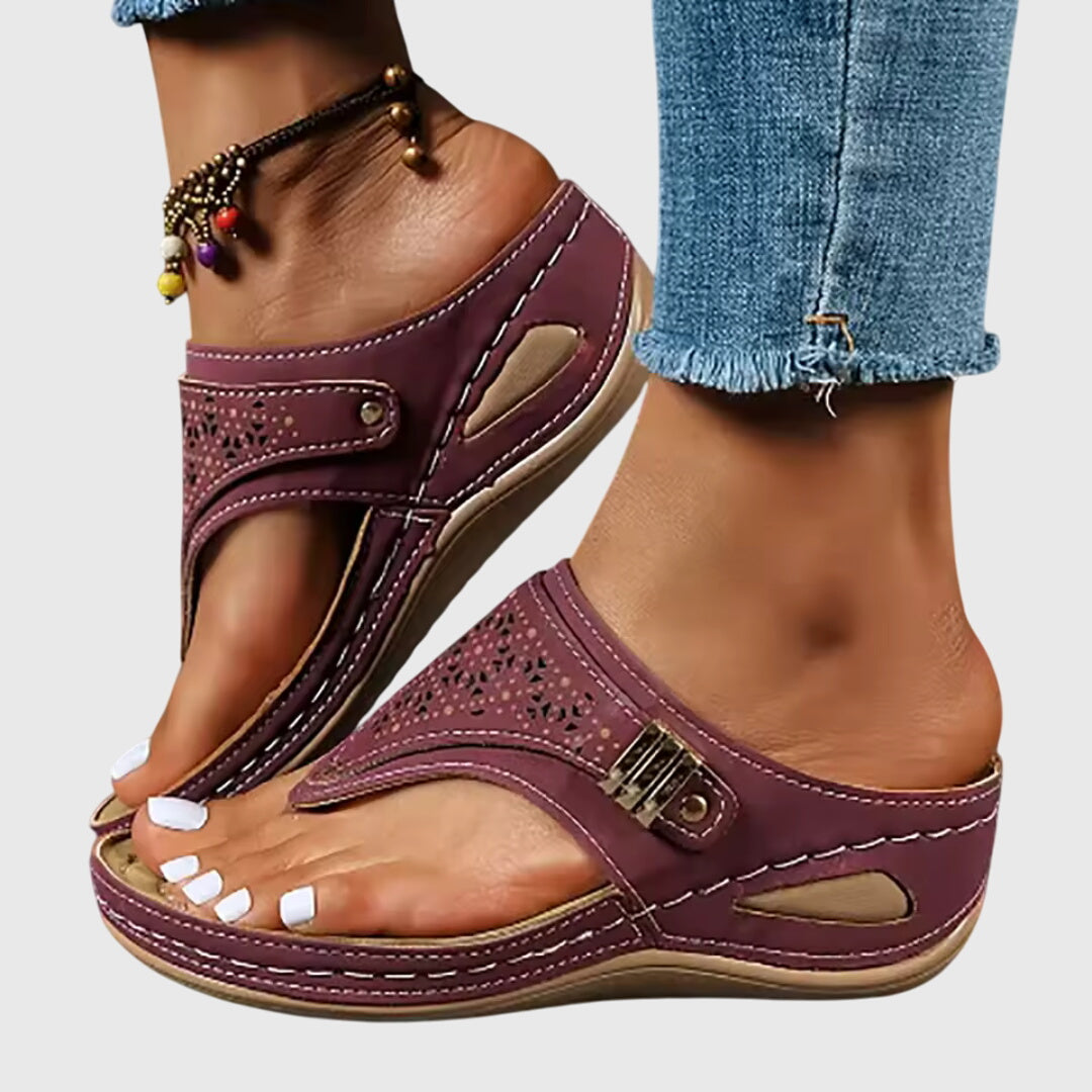 A woman in grey comfort flip-flops relaxing outdoors, feet cushioned and supported.
