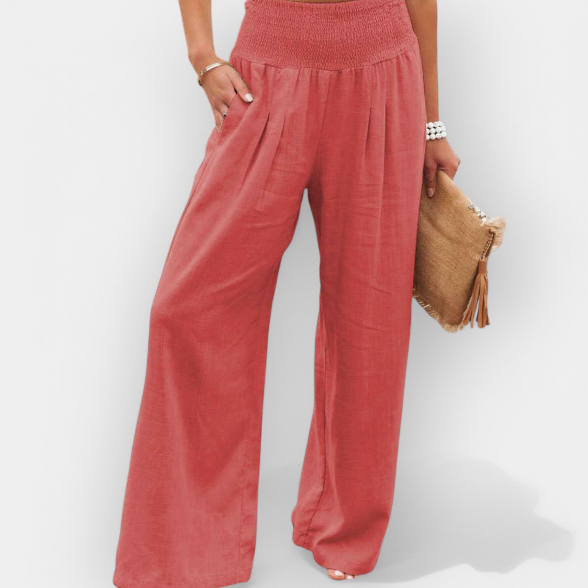 White wide-leg trousers with an elastic waist and a light, flowing silhouette