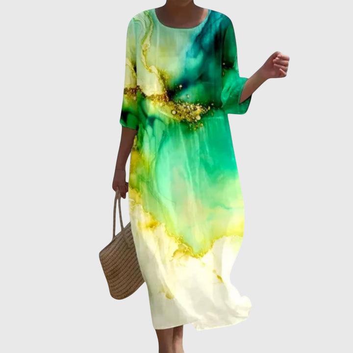 Woman wearing a long flowing maxi dress with a delicate floral print, moving gracefully.