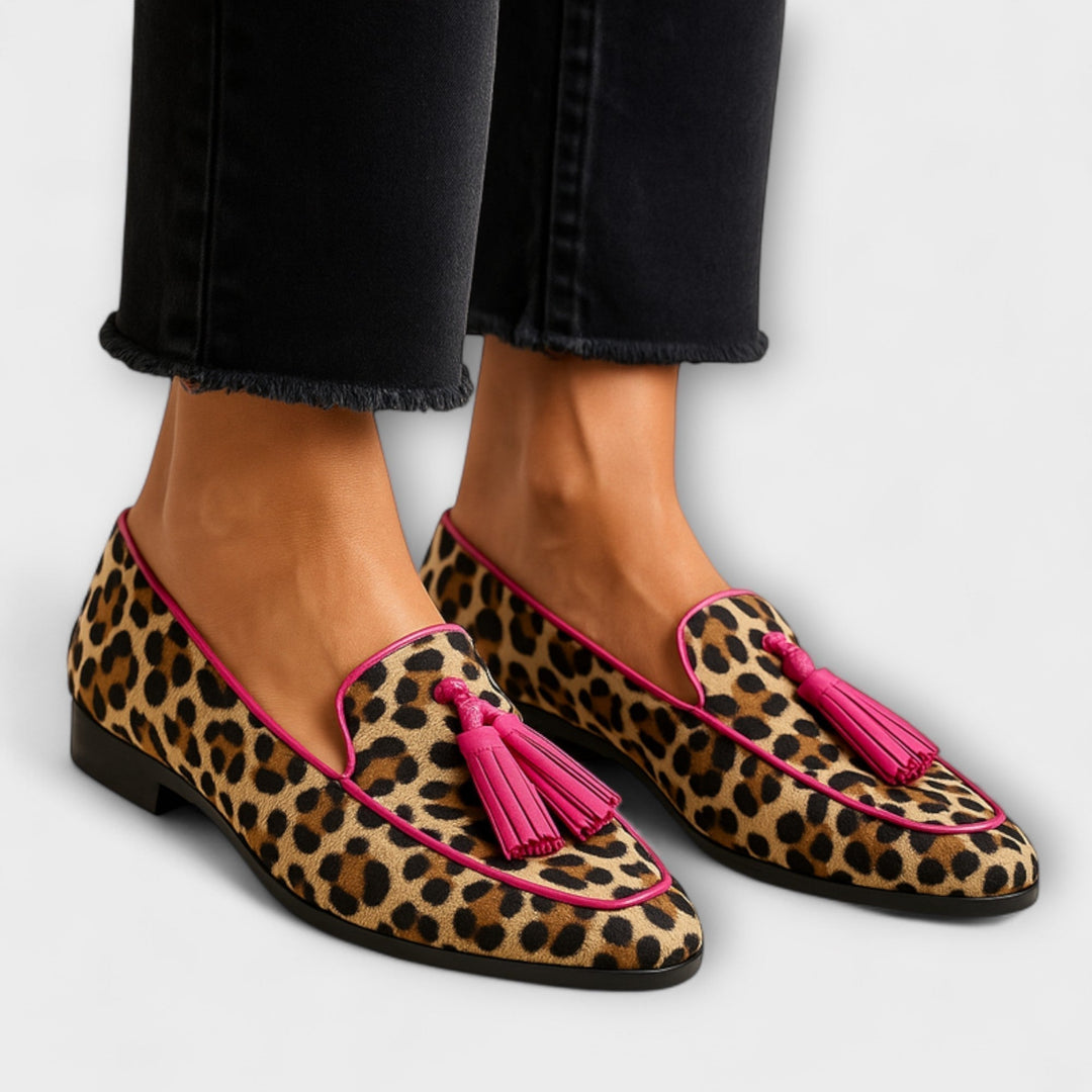 A woman wearing fringe-detail loafers on a stylish day out.