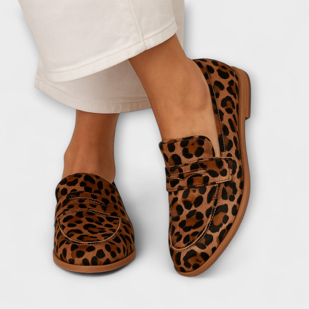 A woman wearing soft slip-on loafers, relaxed and comfortable on an everyday walk.